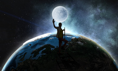 Young woman reaching moon