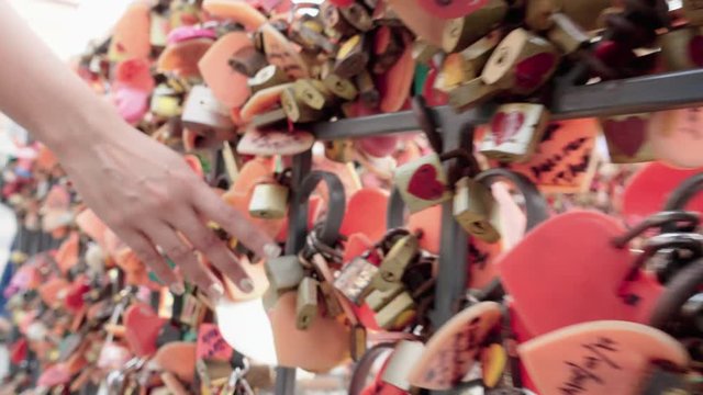 woman hand touching a lock wall 4K stock video