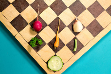Fresh slice vegetables on the cutting chess board.