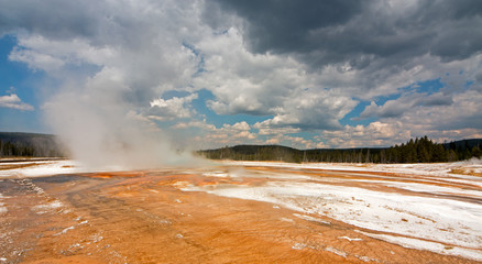 Rainbow Pool hot spring run off past the Cliff Geyser into Iron Spring Creek in Black Sand Basin in...