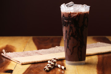 Ice cocoa soft drink on wood floor and topping
