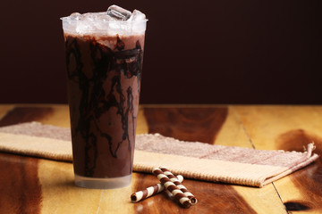 Ice cocoa soft drink on wood floor and topping