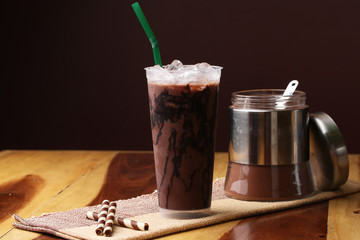 Ice cocoa soft drink on wood floor and topping