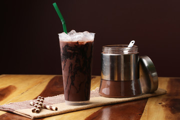 Ice cocoa soft drink on wood floor and topping