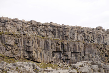 Fototapeta na wymiar Dark and dead basalt columns and a river running below them near the Dettifoss waterfall, Iceland