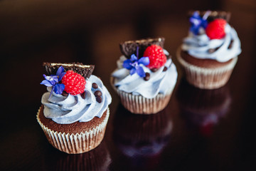 Beautiful and tasty muffins with raspberries and flowers