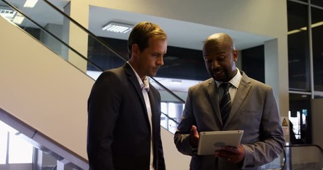 Business people discussing over digital tablet - Powered by Adobe