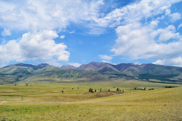 View of Kurai steppe and hills in Altai mountains in cloudy weather. Altay Republic, Siberia, Russia.