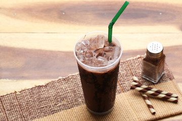 Ice cocoa soft drink on wood floor and topping