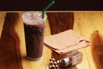 Ice cocoa soft drink on wood floor and topping