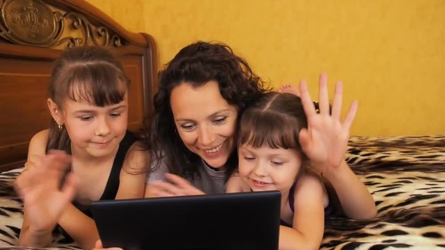 The family communicates on the tablet. Mom and daughter talk on skype.