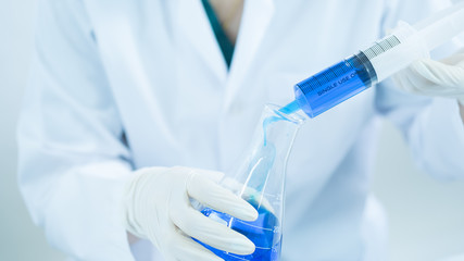 young woman scientist working at the laboratory alone.