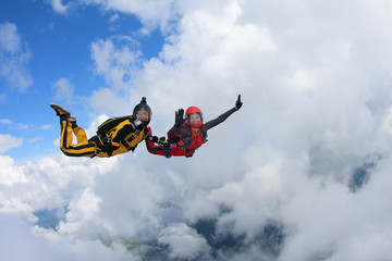 Fototapeta na wymiar Two skydivers are in the sky.