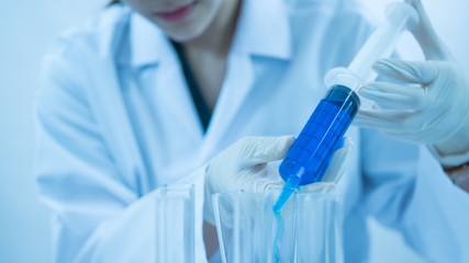 young woman scientist working at the laboratory alone.