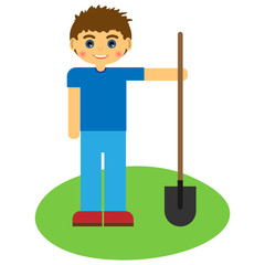 Boy with a shovel on green grass.