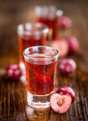 Portion of Cherry Liqueur on wooden background, selective focus
