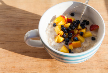 Oat porridge with milk and dried fruits.