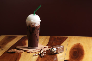 Ice cocoa soft drink on wood floor and topping
