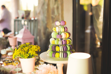 Delicious and tasty dessert table with cupcakes shots at reception closeup