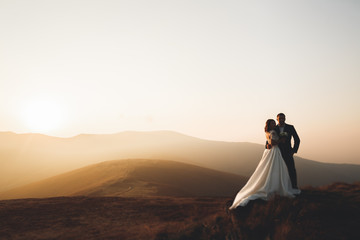 Beautiful gorgeous bride posing to groom and having fun, luxury ceremony at mountains with amazing view, space for text, wedding couple