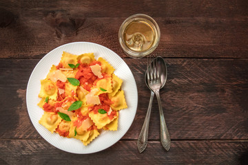Plate of ravioli with tomato sauce and white wine