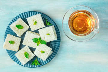 Cucumber sandwiches and tea, shot from above with copy space