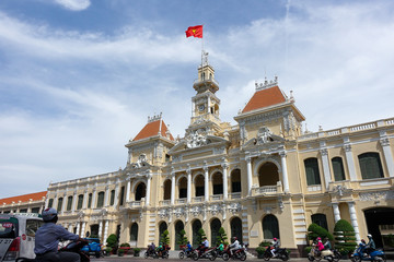 Naklejka premium Ho Chi Minh City, Viet Nam - July 11, 2017: The Ho Chi Minh City Hall, or Ho Chi Minh City People's Committee in sunny day, built in 1902-1908 in a French colonial style for the then city of Saigon