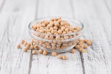 Portion of dried Chickpeas on wooden background, selective focus