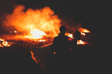 Amazing wedding couple near the fire at night