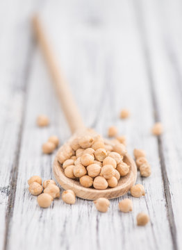 Portion of dried Chickpeas on wooden background, selective focus