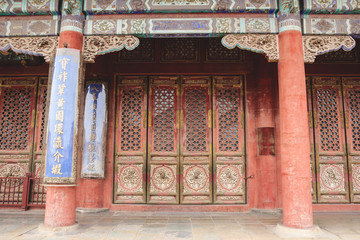 Fototapeta na wymiar A wooden gate- Architectural detail in forbidden city in Beijing, China