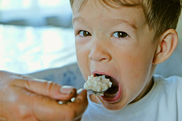 porridge spoon in baby's mouth