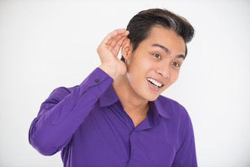 Smiling Asian Man Cupping Hand Behind Ear