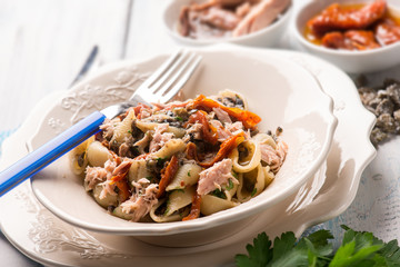 pasta with tuna dried tomatoes and capers, selective focus