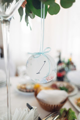 The vase with flowers and number stand on the table