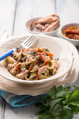 pasta with tuna dried tomatoes and capers, selective focus