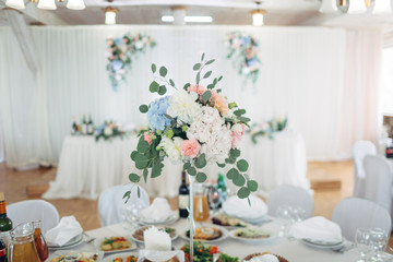 The vase with flowers stands on the table