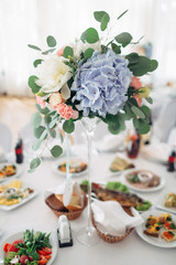 The vase with flowers stands on the table