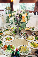 Bouquet of orange and pink flowers stands on the table