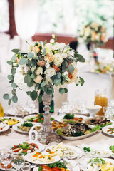 Bouquet of orange and pink flowers stands on the table