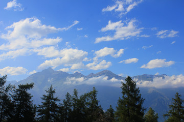panorama with mountains, clouds and trees