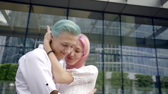 close-up. portrait of loving couple hipsters . they are happy together. enjoy a joint tour of the town. a man with blue hair and pink girl