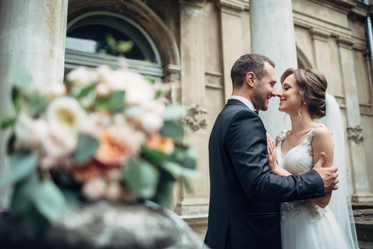 Wedding bouquet lies on the porch where wedding couple stands