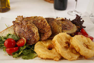 Chicken with breaded pineapple arranged on a plate, Wine bottle and wineglass in background, Traditional dish in elegant setting, Selective focus with soft light