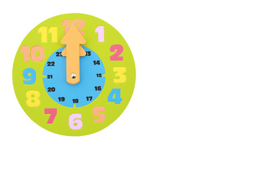 12 O'clock round toy clock isolated on white background with copy space