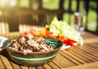 Shish kebab and fresh vegetables on the table.