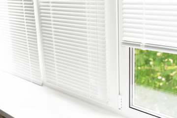 Windows with white venetian blinds.