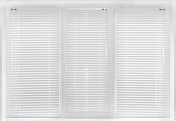 Windows with white venetian blinds.