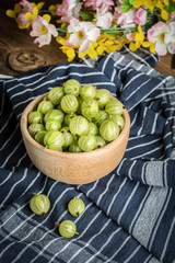 Fresh gooseberry in a wooden bowl.