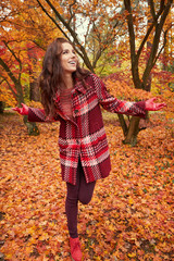 Fashion woman walking in autumn park